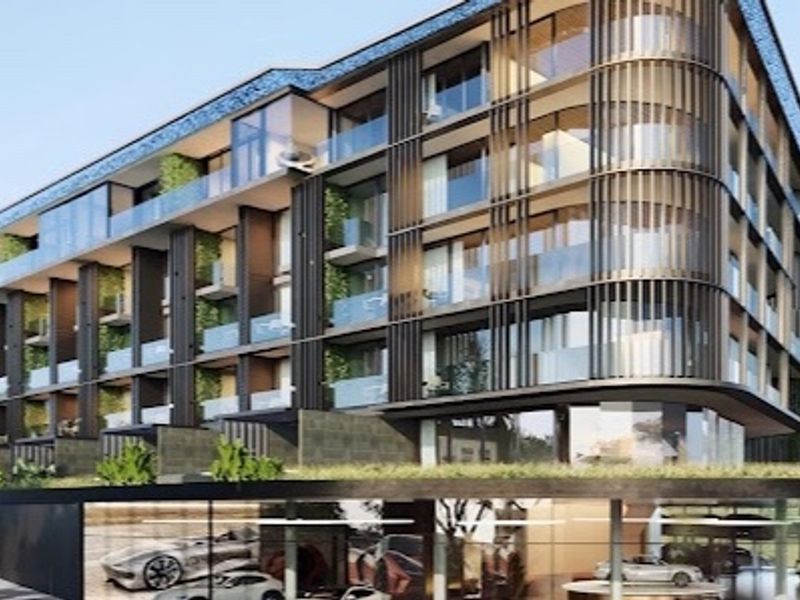 Modern multi-story penthouse building featuring contemporary architectural design, glass balconies, vertical screening, and an integrated underground parking level.