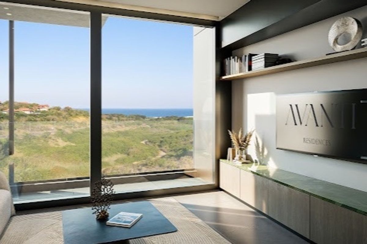 Modern living room featuring custom built-in cabinetry, floating shelves, and expansive floor-to-ceiling windows offering panoramic coastal views.