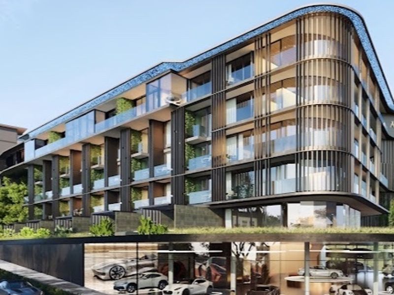 Modern luxury penthouse building exterior featuring a curved facade, glass balconies, and integrated vertical architectural elements.
