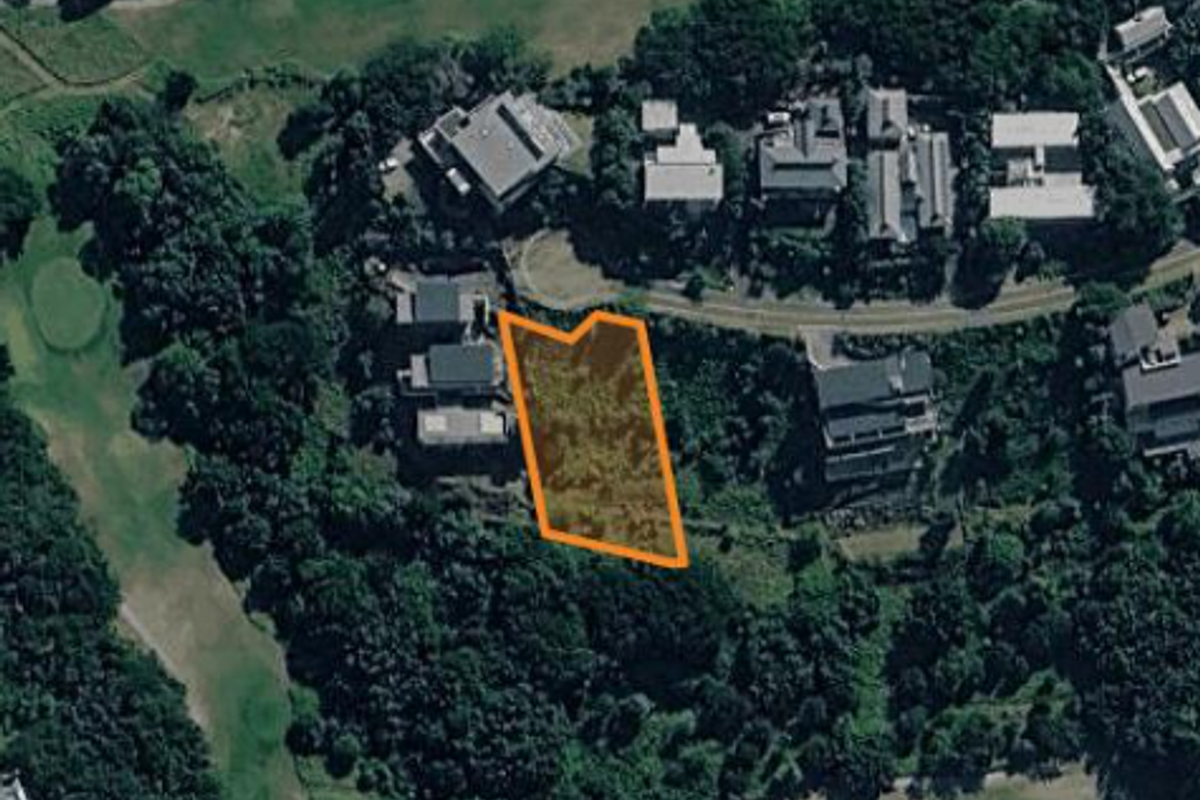 Aerial view of a vacant residential land plot situated within a developed neighborhood, highlighting the property boundaries.