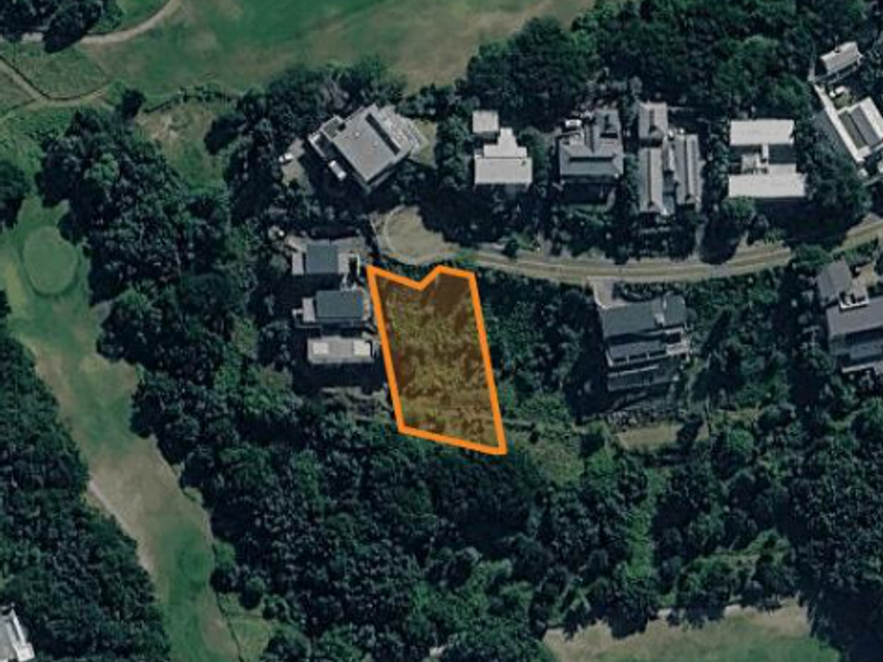 Aerial view of a vacant residential land plot situated within a developed neighborhood, highlighting the property boundaries.