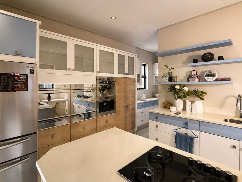 Modern kitchen featuring two-tone cabinetry, stone countertops, integrated appliances, a gas hob, and open shelving for a clean, functional design.