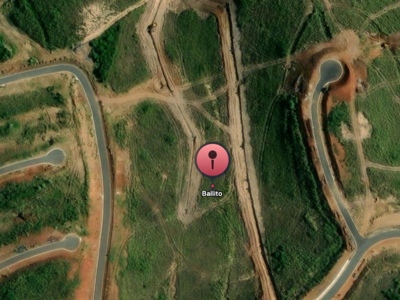 Aerial view of a residential development site in Ballito showing cleared land, earthworks, and established paved road infrastructure.