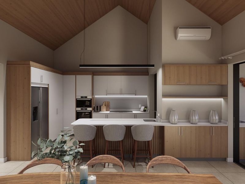 Modern kitchen featuring a vaulted timber ceiling, integrated appliances, a central island with breakfast bar seating, and sleek cabinetry with under-cabinet lighting.