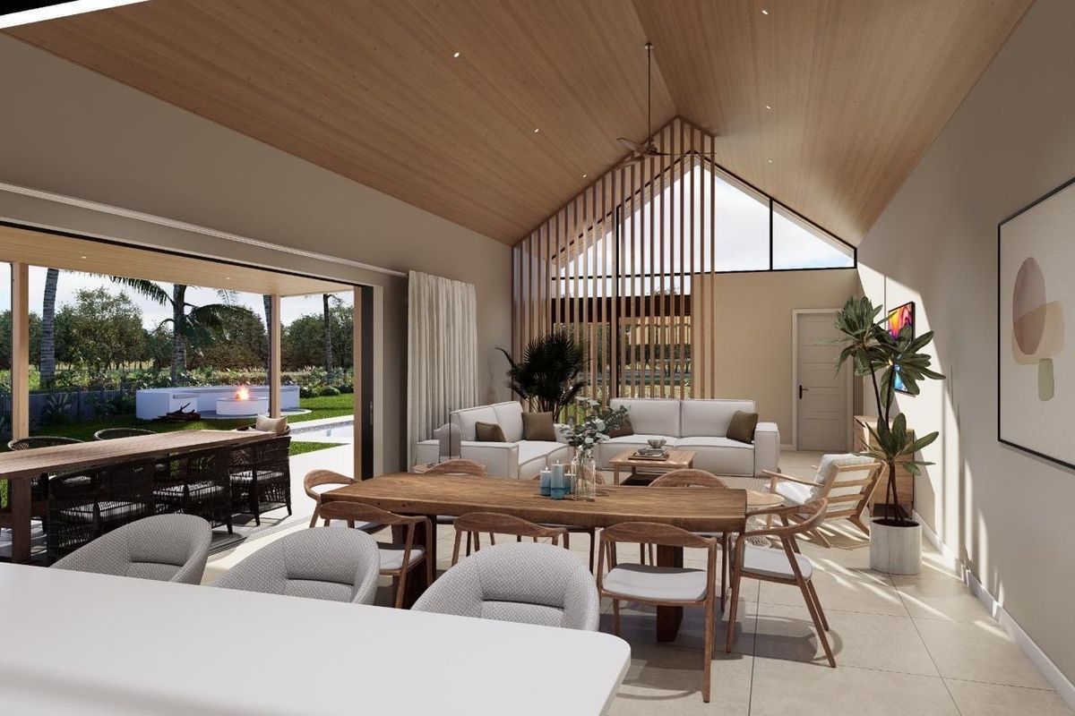Spacious open-plan living and dining area featuring a high vaulted timber ceiling, large sliding doors to the patio, and modern architectural finishes.