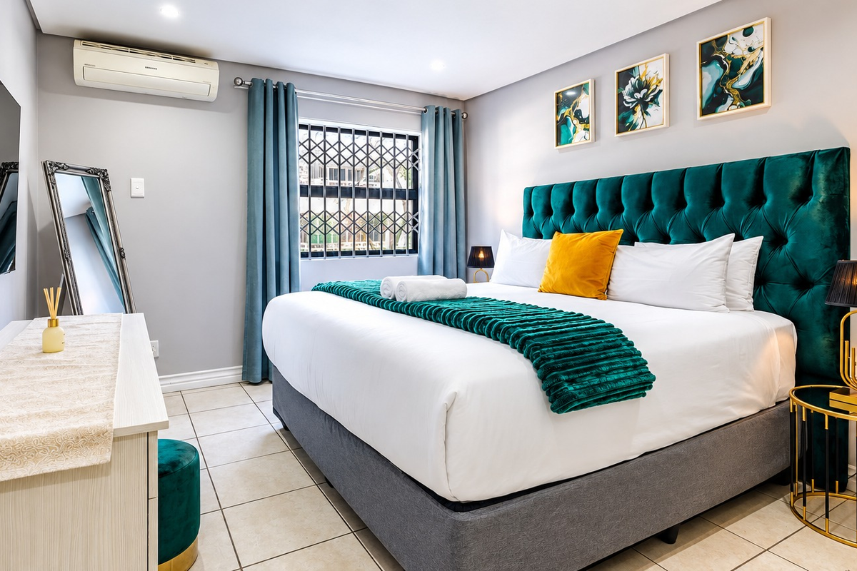 A well-maintained bedroom featuring tiled flooring, a wall-mounted air conditioning unit, and a secure window with a fitted security gate.