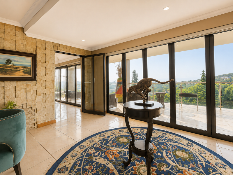 Elegant living area featuring a textured stone feature wall, large glass sliding doors opening to a balcony, and polished tile flooring with scenic views.