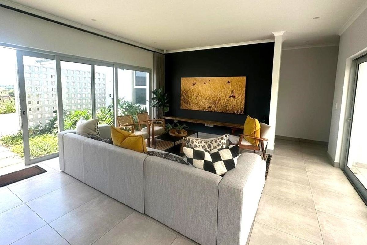 Spacious living room featuring large sliding glass doors that provide abundant natural light and seamless access to the outdoor area.