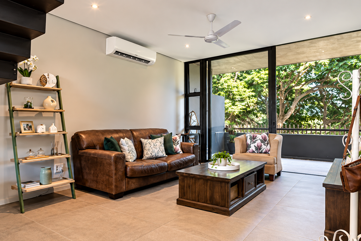 Modern living room featuring tiled flooring, recessed lighting, a ceiling fan, air conditioning, and large sliding glass doors opening to a balcony.