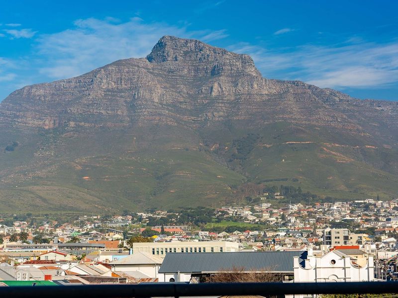 A clear, elevated view of Table Mountain overlooking the surrounding residential neighborhood and urban landscape.