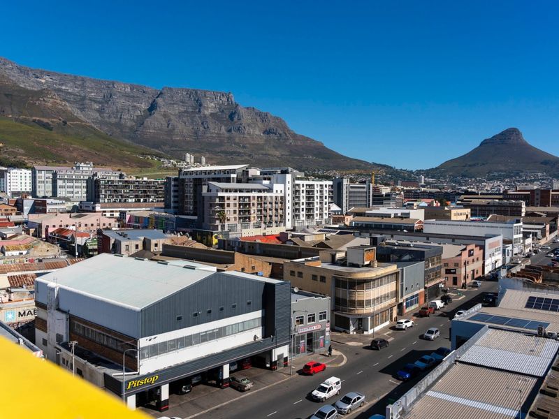 Elevated urban view overlooking the city streets with Table Mountain and Lion's Head in the background.
