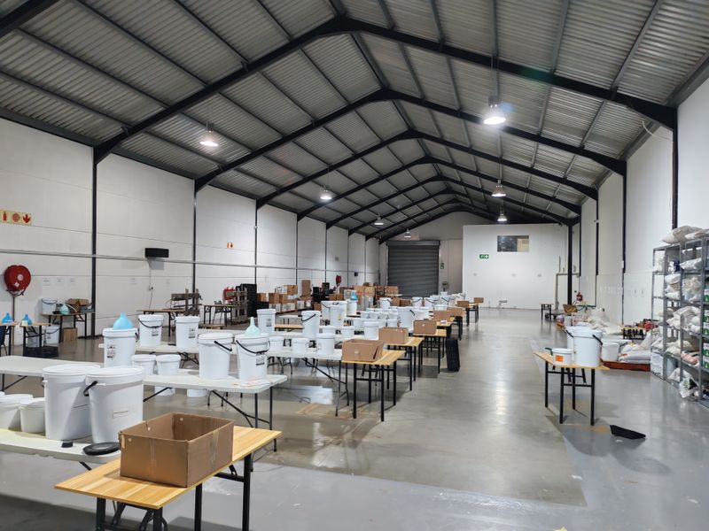 Spacious industrial warehouse featuring a high-clearance steel portal frame, durable epoxy-coated concrete flooring, and a large roller shutter door for efficient access.