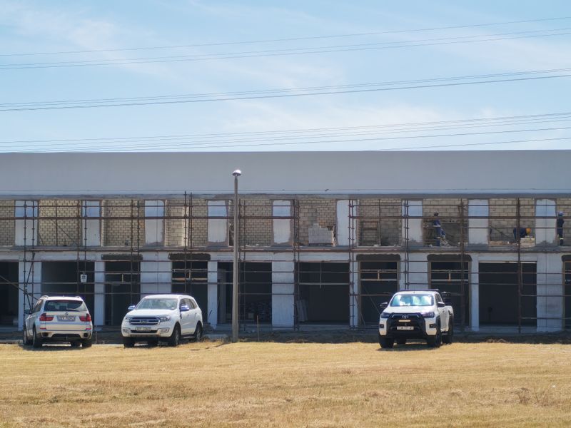 Front elevation of an industrial property currently under construction, featuring exposed brickwork and scaffolding across the facade.