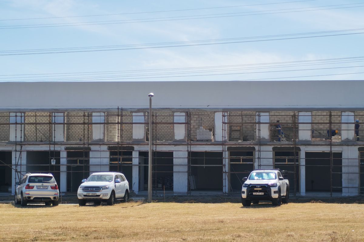 Front elevation of an industrial property currently under construction, featuring exposed brickwork and scaffolding across the facade.