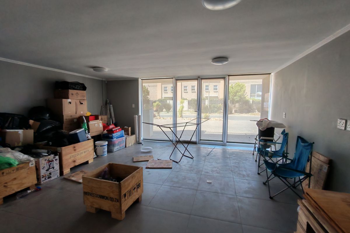 Spacious open-plan living area featuring large sliding glass doors that provide ample natural light and direct access to the exterior.