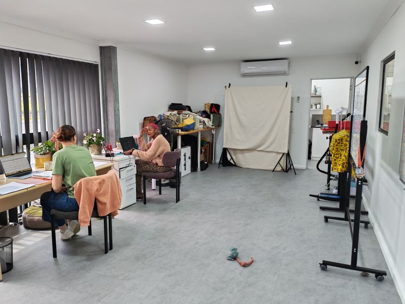 A bright, functional office space featuring recessed downlights, split-system air conditioning, and durable vinyl flooring, suitable for a professional work environment.