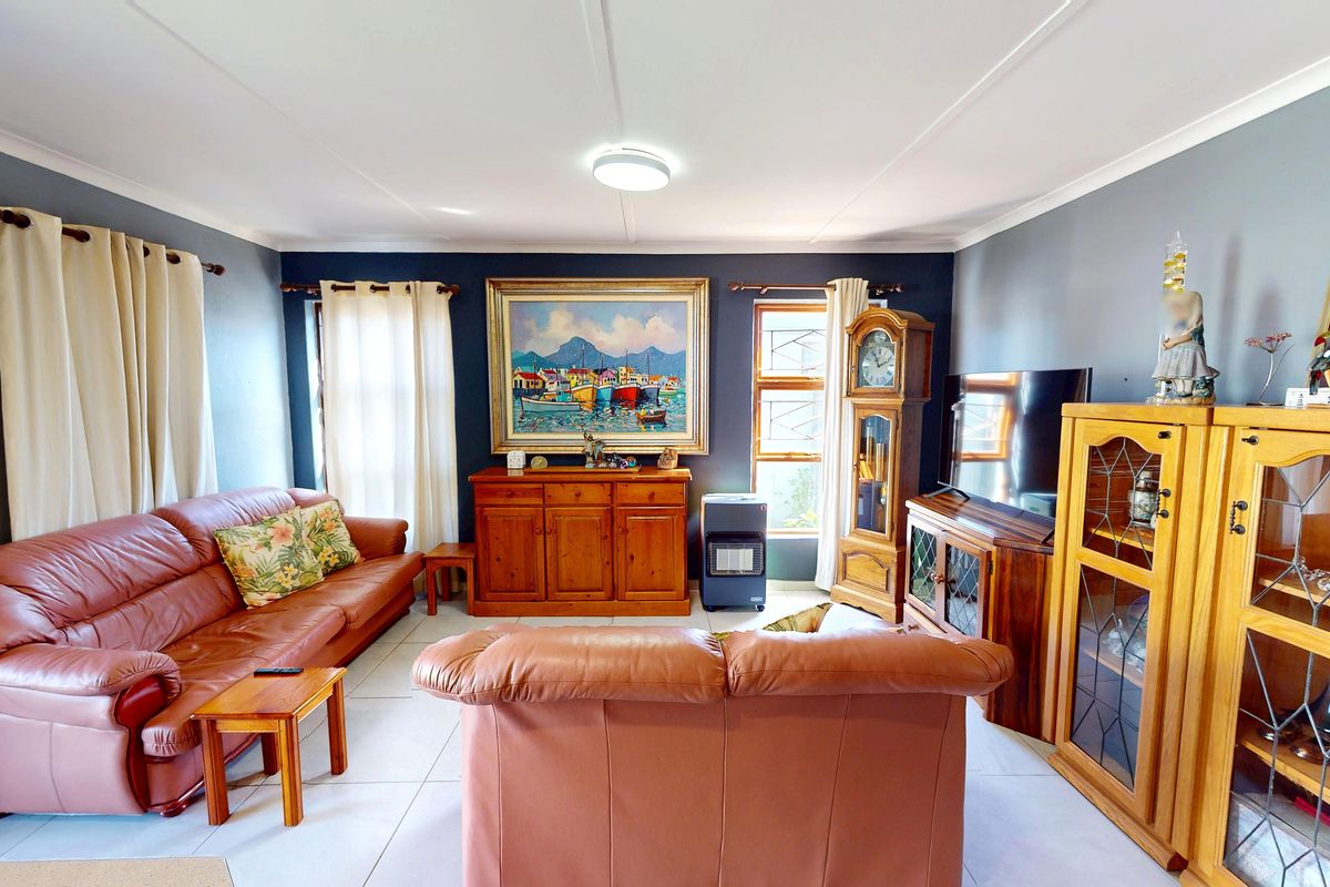 A comfortable living room featuring tiled flooring and neutral wall tones, providing a functional and well-maintained space for relaxation.
