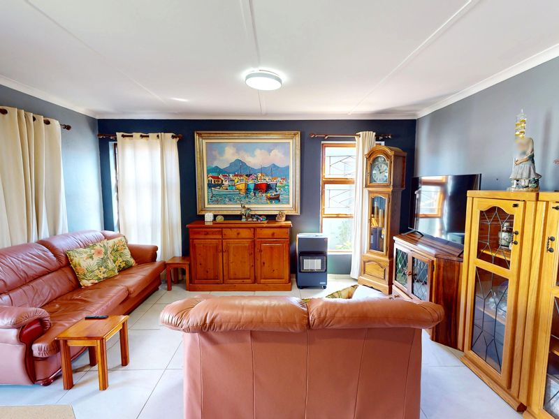 A comfortable living room featuring tiled flooring and neutral wall tones, providing a functional and well-maintained space for relaxation.