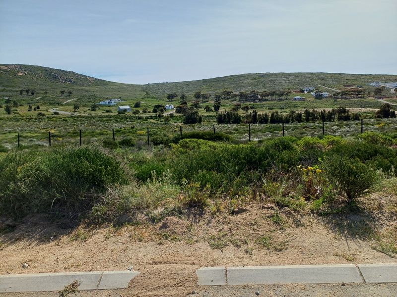 A scenic view of the vacant residential land, showcasing the natural landscape, surrounding hills, and established perimeter fencing.