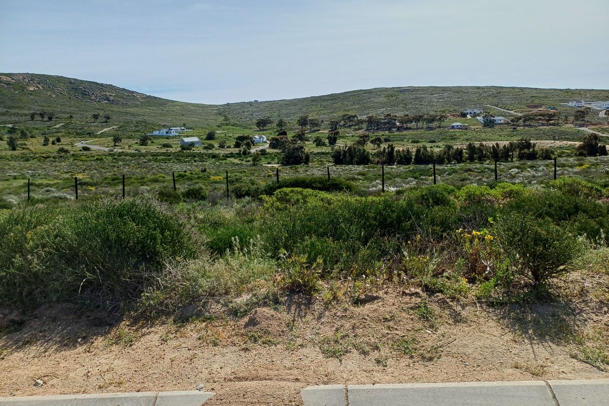 A scenic view of the vacant residential land, showcasing the natural landscape, surrounding hills, and established perimeter fencing.
