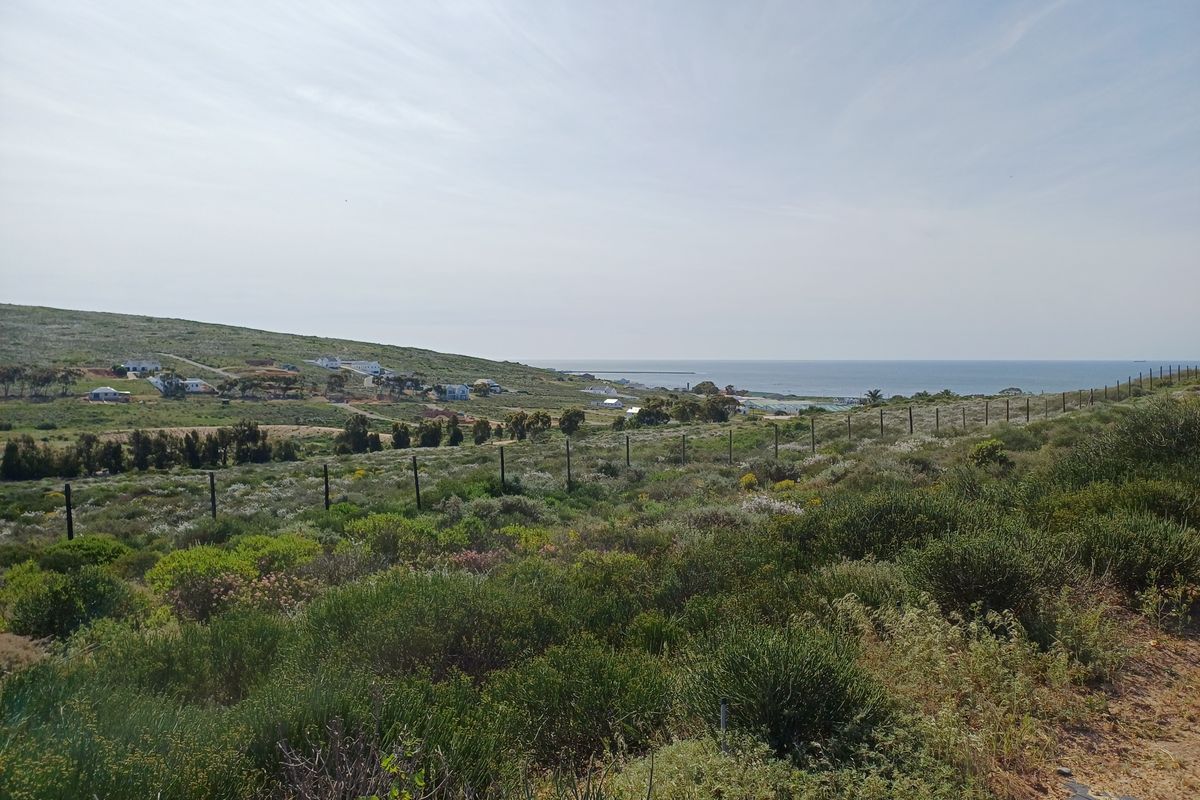 A scenic view of the coastal landscape and surrounding residential area from the vacant residential plot.