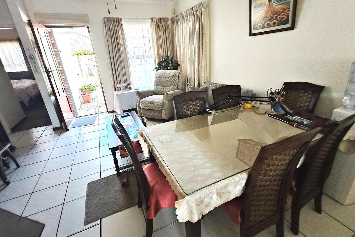 Open plan living and dining area featuring ceramic floor tiles and direct access to an outdoor patio area.