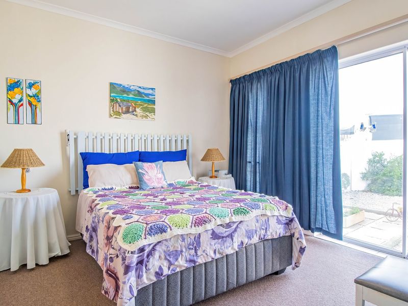 A bedroom featuring carpeted flooring, cove cornicing, and a large sliding glass door providing access to the exterior.