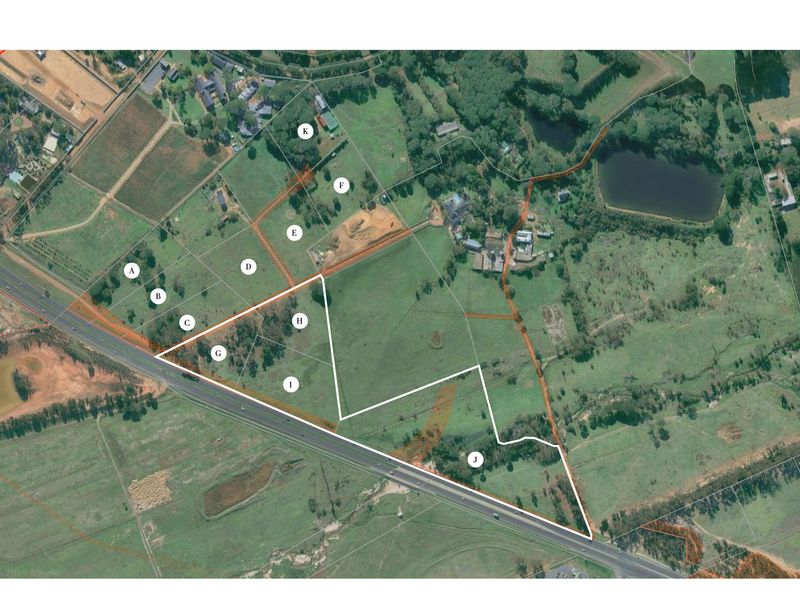Aerial view of a large residential vacant land parcel with marked boundaries and plot identifiers.