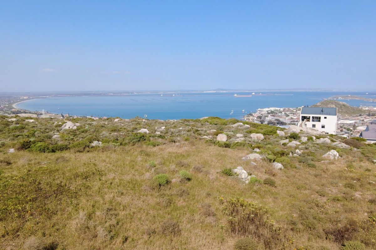 Elevated view overlooking the coastal landscape, bay, and surrounding residential area, showcasing the natural terrain and scenic outlook.