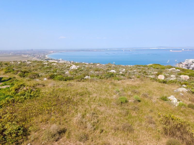 An elevated view overlooking the coastal landscape and bay area, showcasing the natural terrain and surrounding environment.