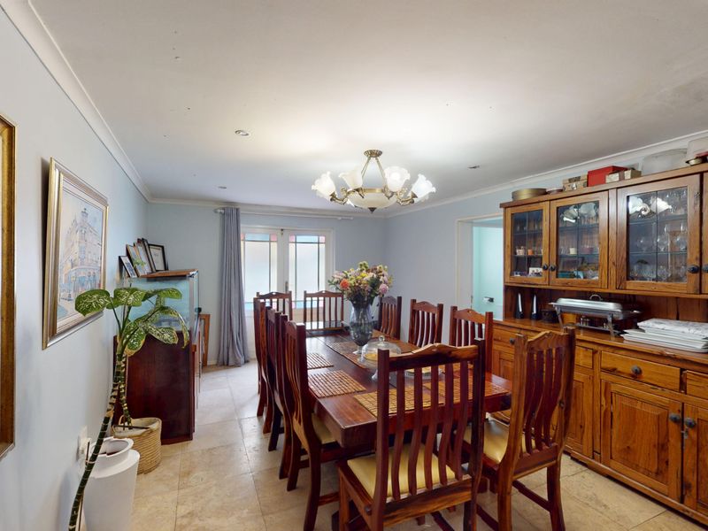 A formal dining room featuring tiled flooring, recessed lighting, and access to the exterior via french doors.