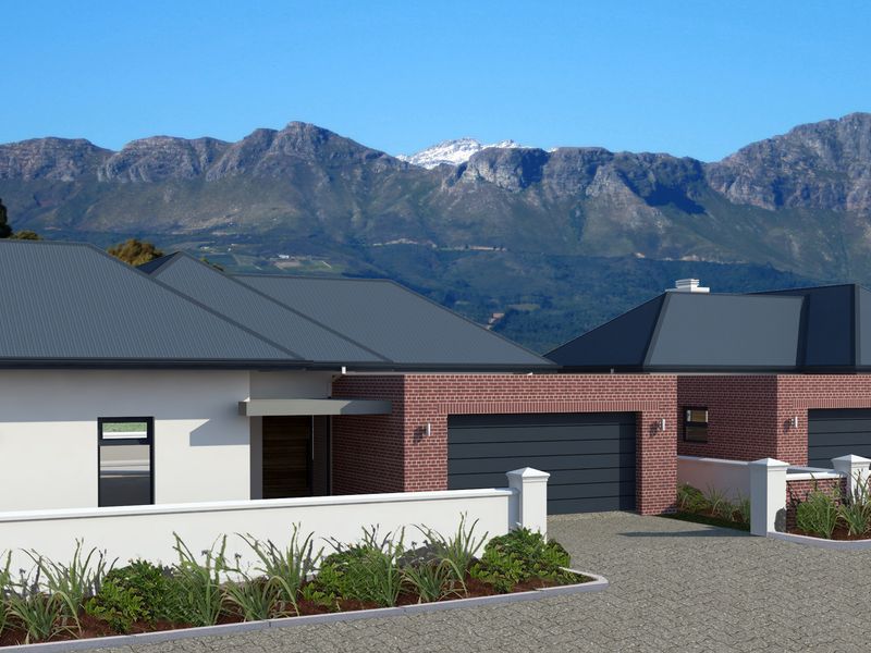 A modern residential development featuring brick and rendered facades, metal roofing, and paved driveways with scenic mountain views in the background.