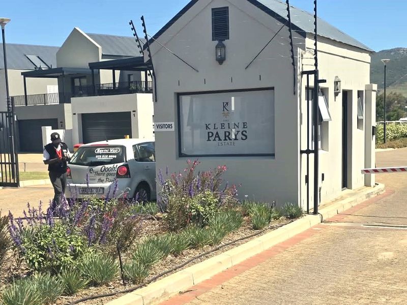 The entrance gatehouse of Kleine Parys Estate, featuring secure access control, electric fencing, and a paved driveway.