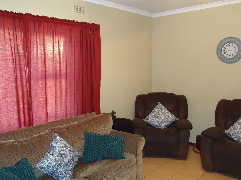 A living room area featuring tiled flooring and neutral wall finishes, providing a functional space for relaxation.