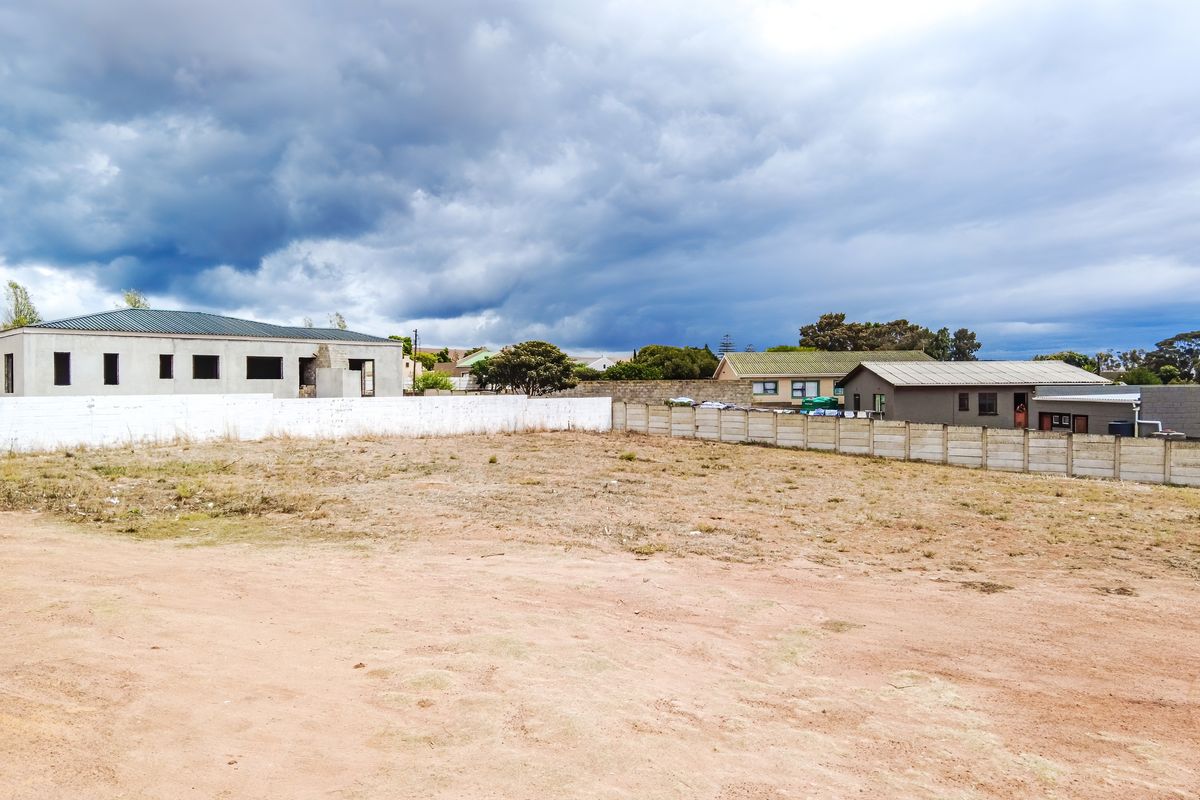 A vacant residential plot featuring a level surface, enclosed by perimeter boundary walls, situated in an established neighbourhood.