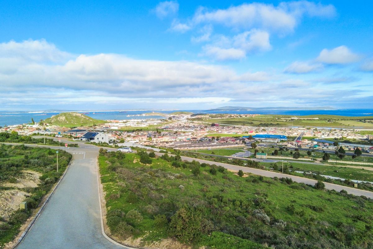 An elevated aerial view showcasing the surrounding landscape, coastal proximity, and local neighborhood infrastructure.