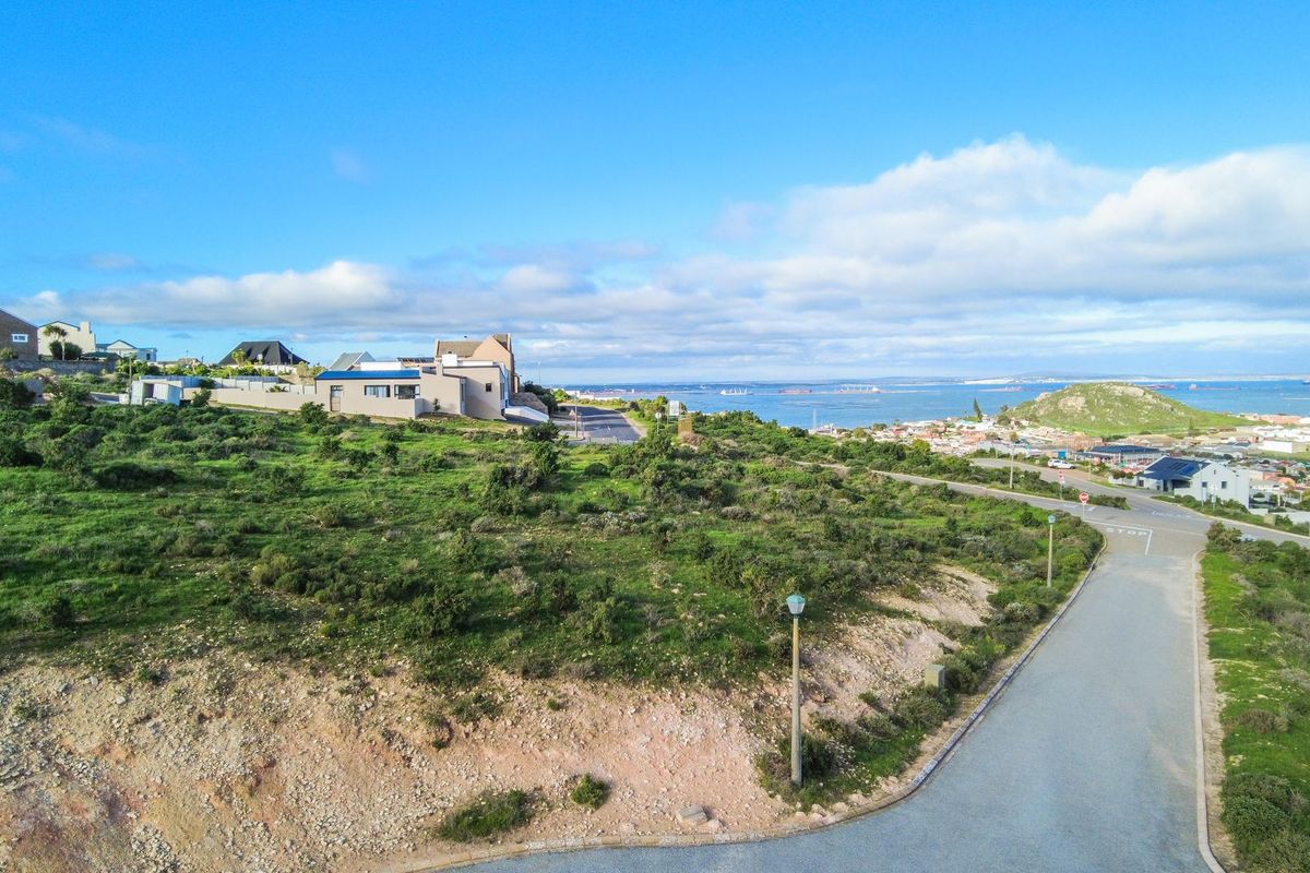 An elevated aerial view showcasing the coastal landscape, surrounding neighborhood, and proximity to the ocean.