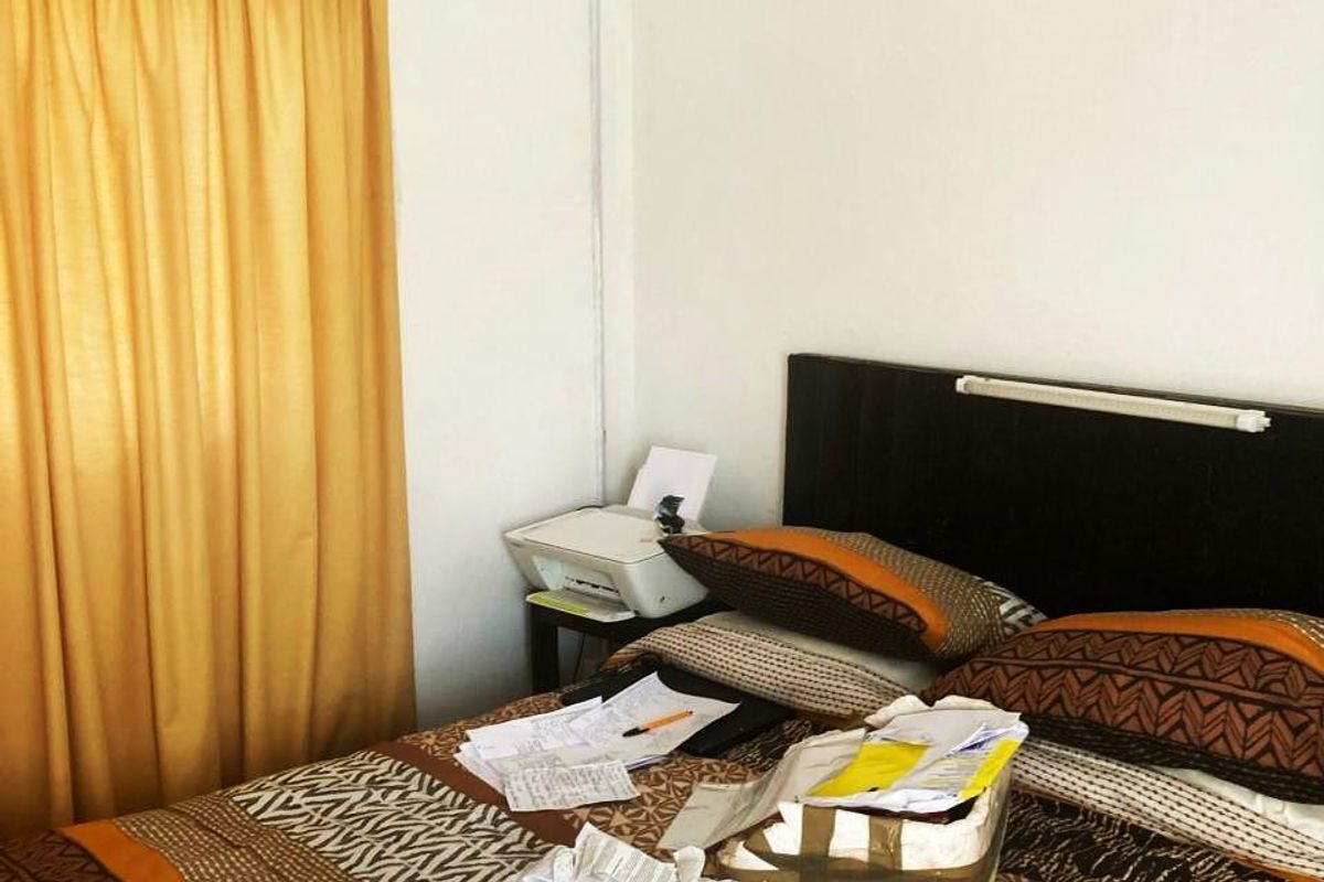 A bedroom featuring a built-in headboard and curtain rail, providing a functional space for rest.