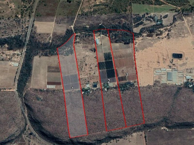 Aerial view of the farm property highlighting three distinct land parcels marked for identification.