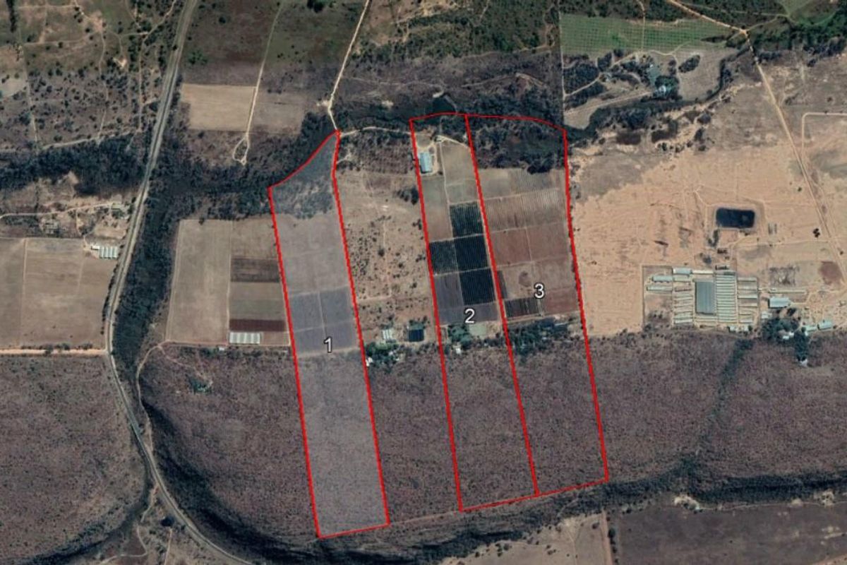 Aerial view of the farm property highlighting three distinct land parcels marked for identification.