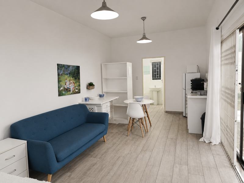 Open-plan living area featuring tiled floors, pendant lighting, and a sliding door leading to the exterior, with an adjacent kitchen and bathroom access.
