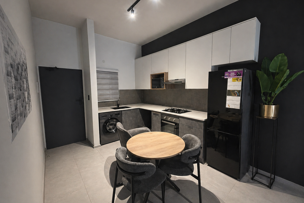 Modern kitchen featuring sleek two-tone cabinetry, integrated appliances, gas hob, and tiled flooring, offering a contemporary and functional culinary space.