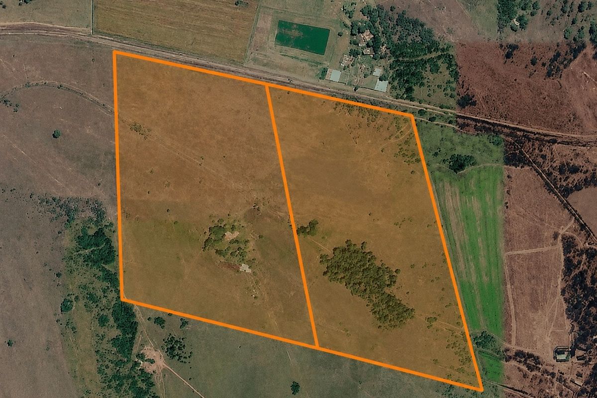 Aerial view of a large farm property featuring expansive open pasture land with clearly marked boundary lines.