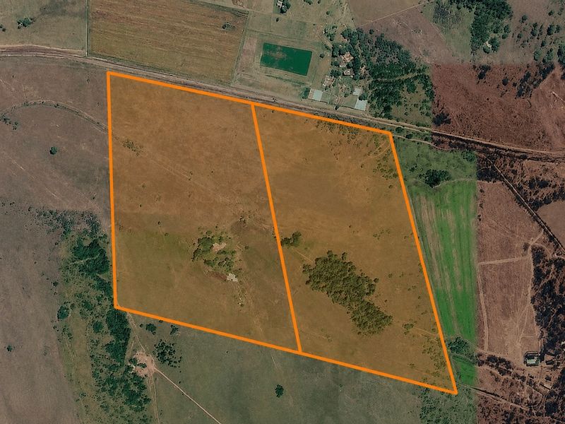 Aerial view of a large farm property featuring expansive open pasture land with clearly marked boundary lines.