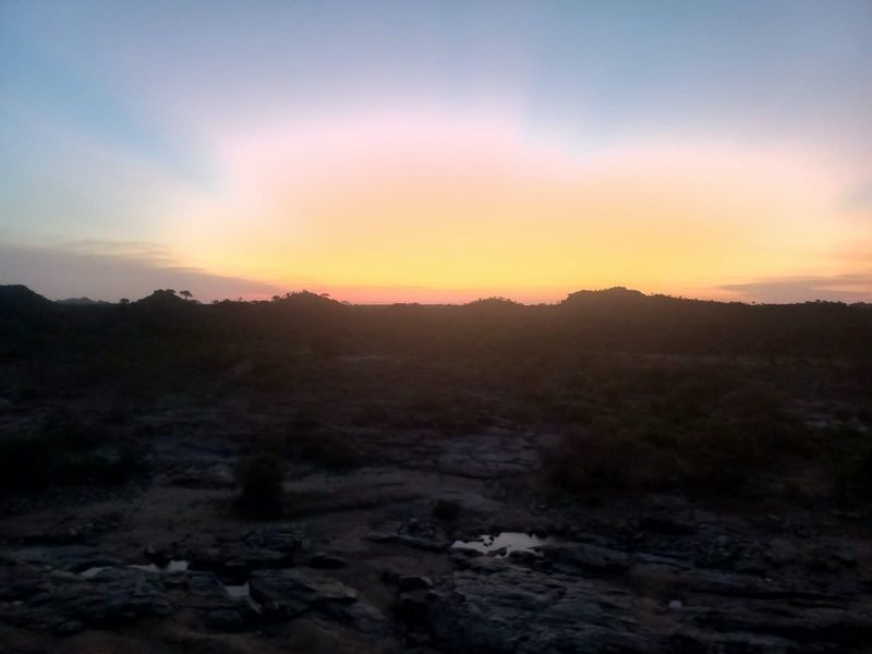 A scenic sunset view over the natural landscape, showcasing the property's expansive rural surroundings.