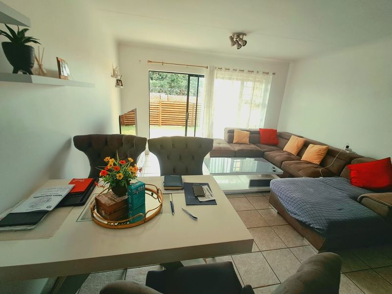 Open plan living and dining area featuring tiled flooring and a sliding glass door providing access to the exterior.