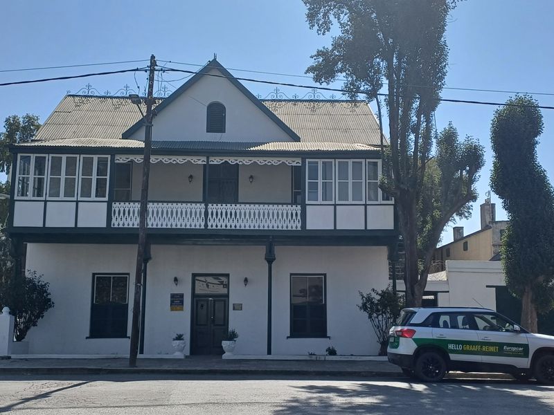 A well-maintained historic two-story office building featuring a classic facade, timber balcony with decorative fretwork, and traditional sash windows.