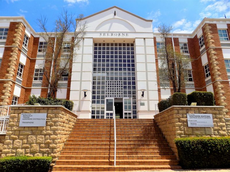 Front elevation of the Selborne office building featuring a prominent glass entrance, brick facade, and stone-walled staircase leading to the main entry.