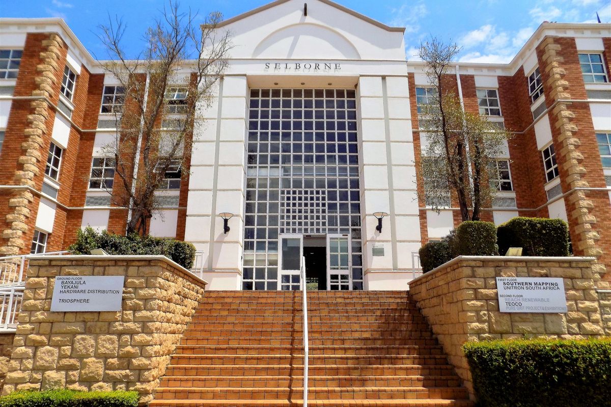 Front elevation of the Selborne office building featuring a prominent glass entrance, brick facade, and stone-walled staircase leading to the main entry.