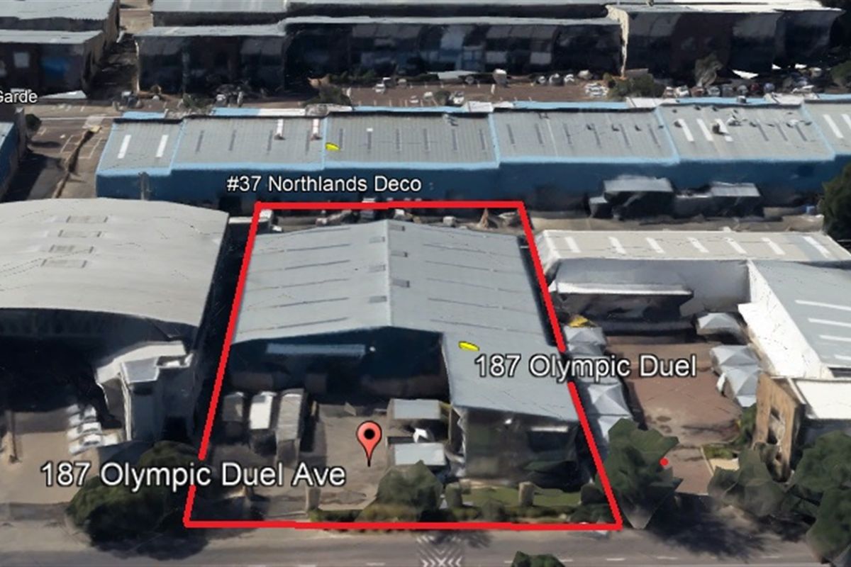 Aerial view of the industrial property located at 187 Olympic Duel Avenue, highlighting the warehouse structure and surrounding yard space.
